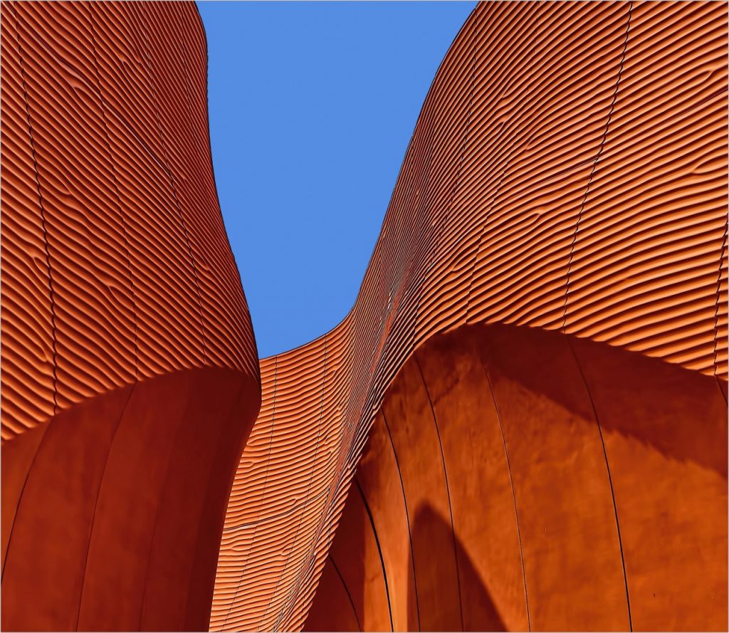 Orange architectural detail against a blue sky